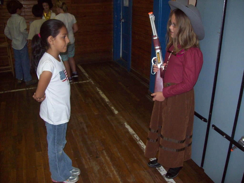 Coupland student listens to "Annie Oakley" during Mrs. Ferguson's Living History Museum.
