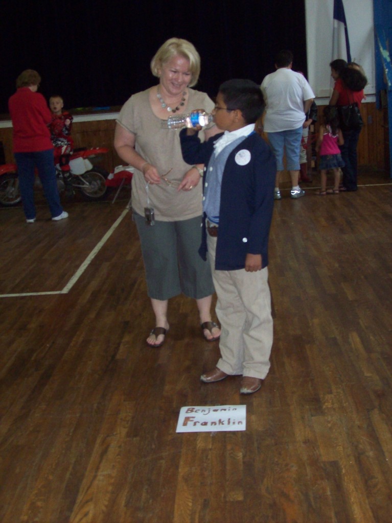 Mrs. Ferguson speaks with "Benjamin Franklin" at a past Living History Museum.