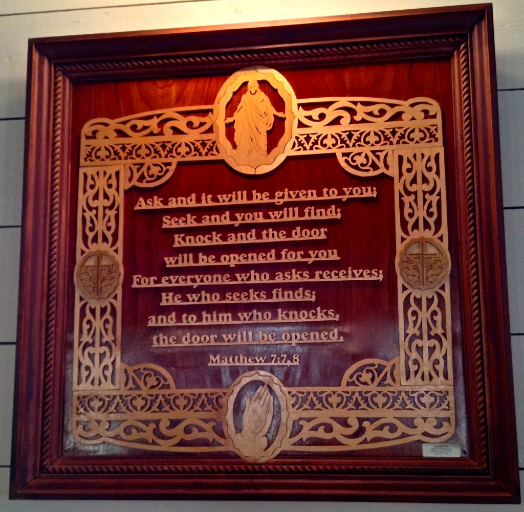 One of the hand-carved, wooden scripture plaques in the sanctuary.