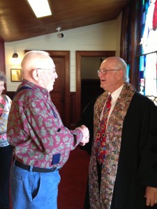 Pastor Frank chats with a member of the congregation at the close of services on May 12.