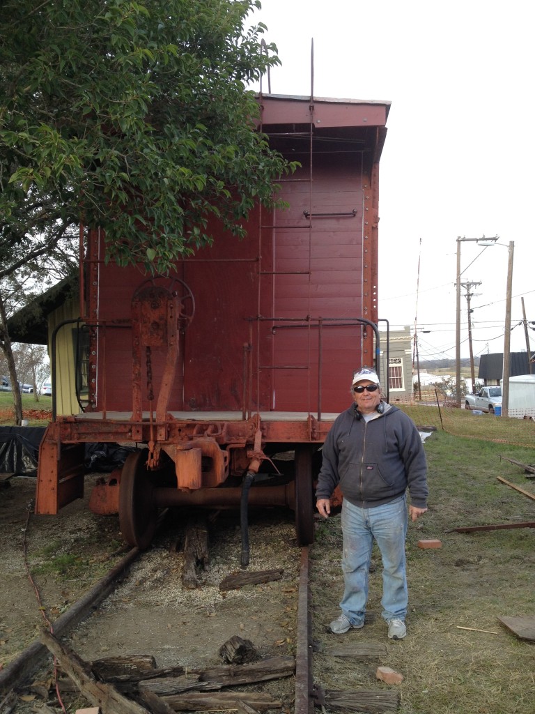 Painter Bryan Sonnet stops for a picture on December 11. He said the first coat of paint was mostly finished. He noted that the prep work was the hardest part. He expects to complete work this week if the weather holds. 